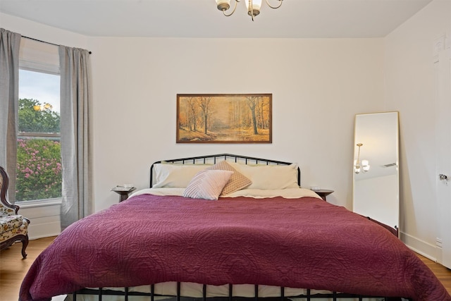 501 Branch St, Taylor, TX 76574 - bedroom featuring multiple windows, wood finished floors, and a chandelier