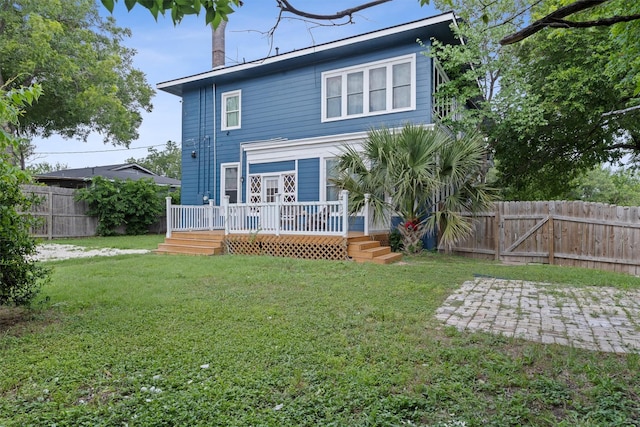 501 Branch St, Taylor, TX 76574 - rear view of house with a fenced backyard, a wooden deck, a patio, and a gate