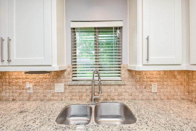 5815 Dryad Dr, Houston, TX 77035 - kitchen view of white cabinets, light stone counters, and decorative backsplash