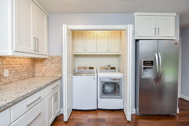 5815 Dryad Dr, Houston, TX 77035 - laundry area with washing machine and clothes dryer, dark wood-style floors, and cabinet space