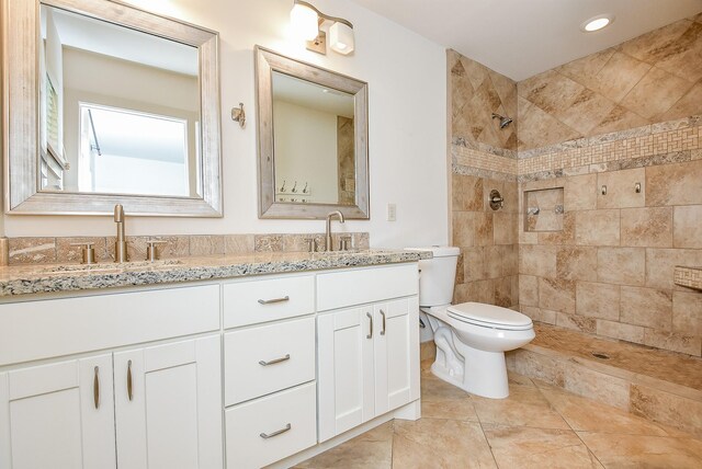 5815 Dryad Dr, Houston, TX 77035 - bathroom featuring double vanity, tiled shower, and recessed lighting