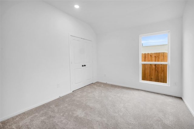 5214 Lake Trout Ln, Baytown, TX 77521 - carpeted empty room with lofted ceiling and recessed lighting