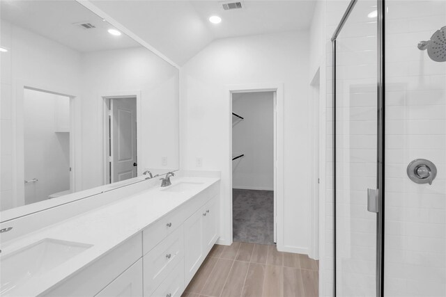 5214 Lake Trout Ln, Baytown, TX 77521 - full bathroom featuring a shower stall, double vanity, recessed lighting, and vaulted ceiling