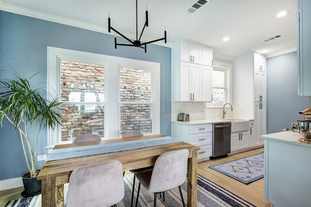 1917 Brun St, Houston, TX 77019 - dining room with light wood finished floors, ornamental molding, and recessed lighting