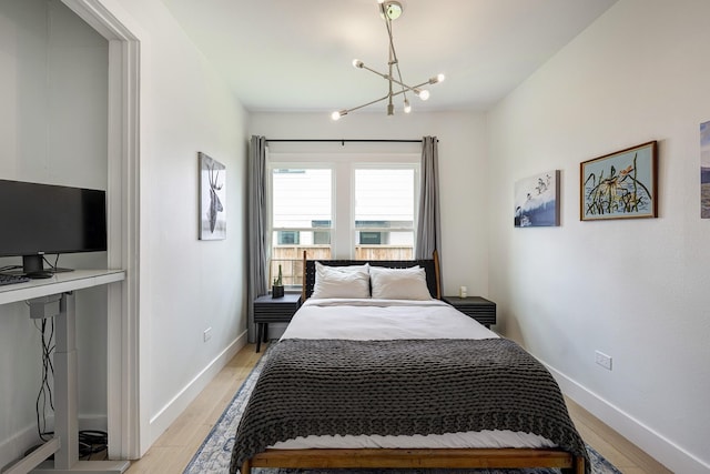 1917 Brun St, Houston, TX 77019 - bedroom featuring a chandelier and light wood finished floors
