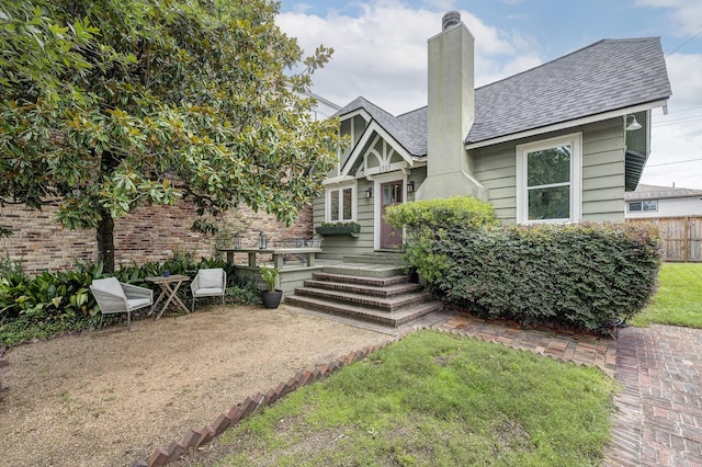 1917 Brun St, Houston, TX 77019 - view of front of house with a chimney and a shingled roof