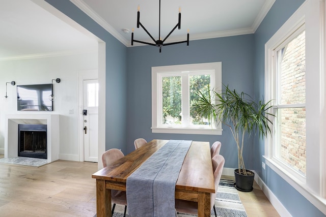 1917 Brun St, Houston, TX 77019 - dining room with a chandelier, light wood-type flooring, crown molding, and a fireplace
