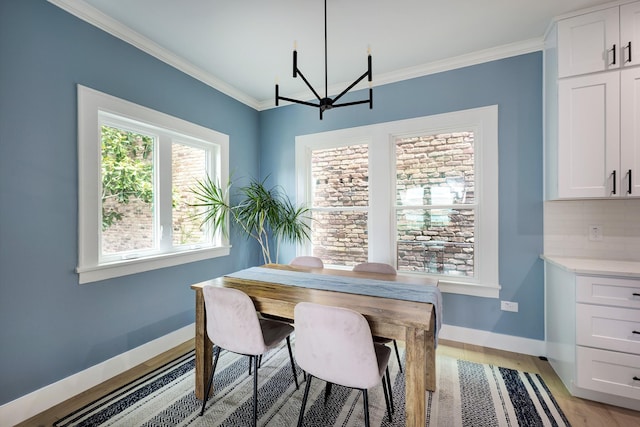 1917 Brun St, Houston, TX 77019 - dining room with a chandelier, crown molding, and light wood-style flooring