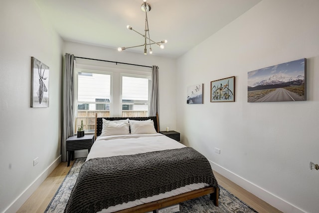 1917 Brun St, Houston, TX 77019 - bedroom with a chandelier and light wood-style flooring