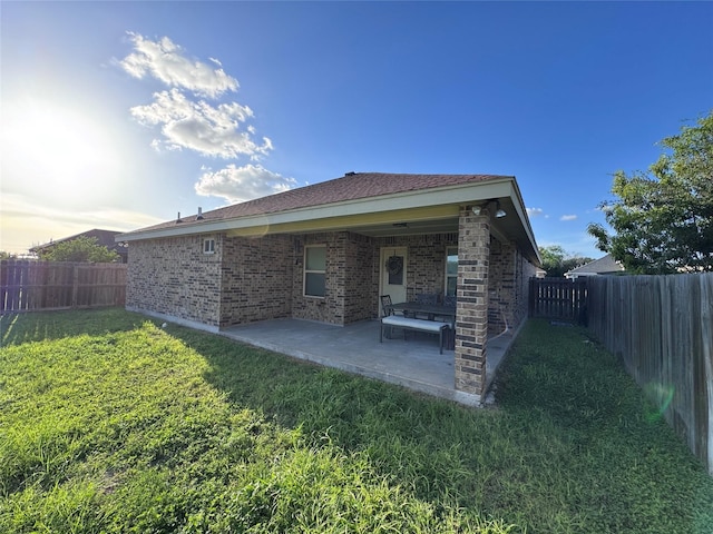 3237 Zircon Dr, Edinburg, TX 78541 - back of house with a fenced backyard, a patio area, and brick siding