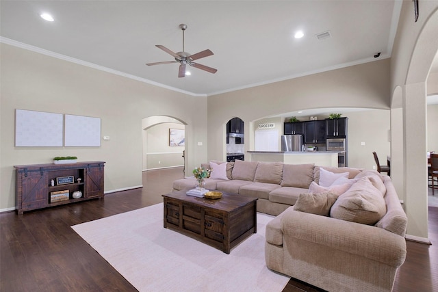 7518 Tejas Lakes Trl, Needville, TX 77461 - living area featuring arched walkways, ceiling fan, ornamental molding, dark wood-style flooring, and recessed lighting