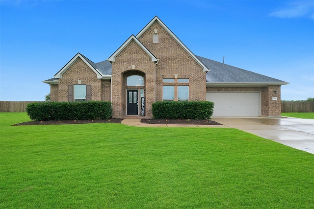 7518 Tejas Lakes Trl, Needville, TX 77461 - traditional-style home featuring brick siding, concrete driveway, a front lawn, an attached garage, and roof with shingles