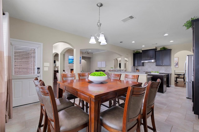 7518 Tejas Lakes Trl, Needville, TX 77461 - dining space featuring arched walkways, a chandelier, and recessed lighting