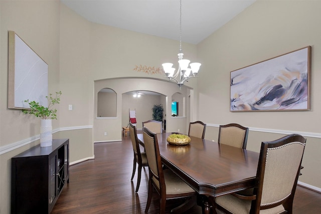 7518 Tejas Lakes Trl, Needville, TX 77461 - dining space with arched walkways, dark wood-style floors, high vaulted ceiling, and a chandelier