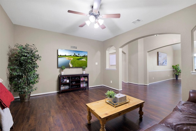 7518 Tejas Lakes Trl, Needville, TX 77461 - living room featuring arched walkways, wood finished floors, and a ceiling fan