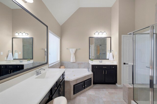 7518 Tejas Lakes Trl, Needville, TX 77461 - bathroom with a stall shower, two vanities, vaulted ceiling, and a whirlpool tub