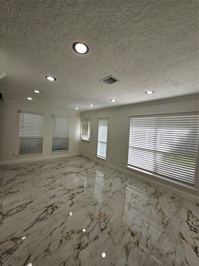 9207 Dairy View Ln, Houston, TX 77099 - unfurnished living room featuring recessed lighting, a textured ceiling, marble finish floors, and crown molding