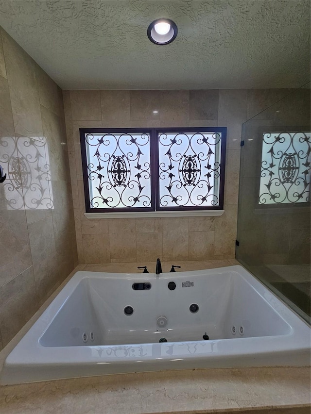 9207 Dairy View Ln, Houston, TX 77099 - full bathroom featuring a jetted tub and a textured ceiling