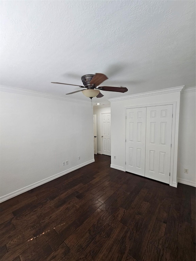 9207 Dairy View Ln, Houston, TX 77099 - unfurnished bedroom featuring dark wood-style flooring, crown molding, a closet, a textured ceiling, and ceiling fan