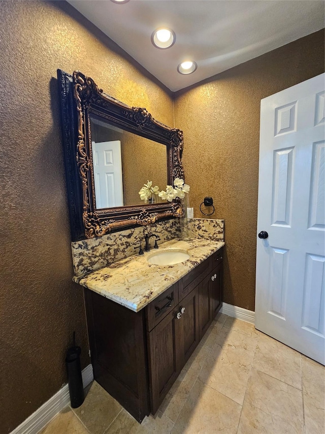 9207 Dairy View Ln, Houston, TX 77099 - bathroom with vanity, a textured wall, and recessed lighting
