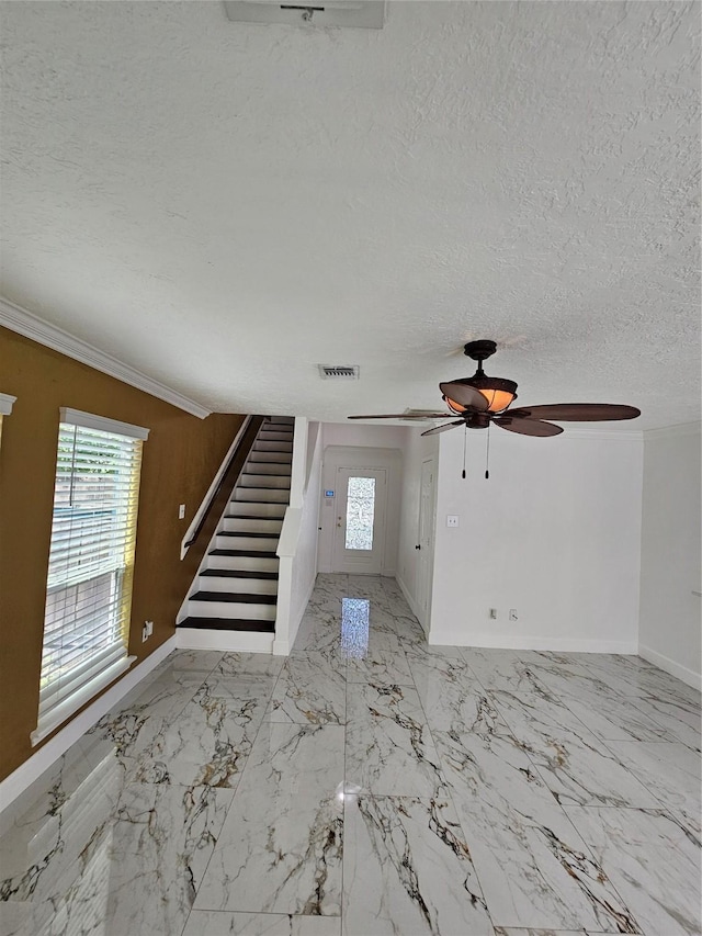 9207 Dairy View Ln, Houston, TX 77099 - foyer featuring stairway, a textured ceiling, ornamental molding, ceiling fan, and marble finish flooring