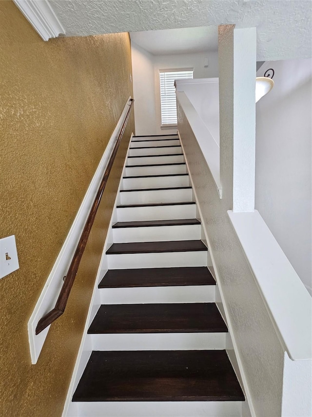 9207 Dairy View Ln, Houston, TX 77099 - stairway featuring a textured ceiling