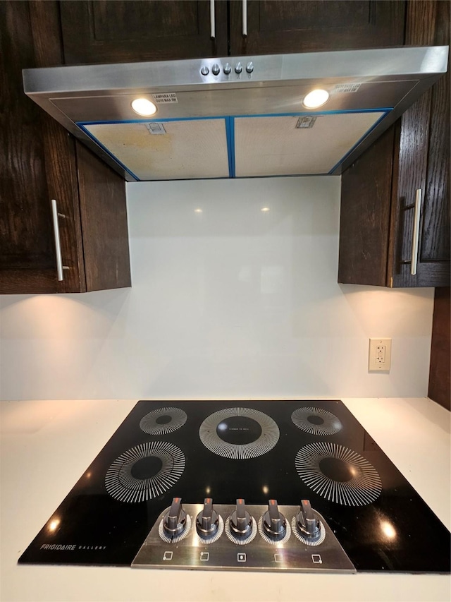 9207 Dairy View Ln, Houston, TX 77099 - kitchen view of ventilation hood, black electric cooktop, and dark brown cabinetry