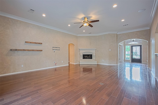 14610 Sandler Ct, Cypress, TX 77429 - unfurnished living room featuring a ceiling fan, arched walkways, wood finished floors, a high end fireplace, and recessed lighting
