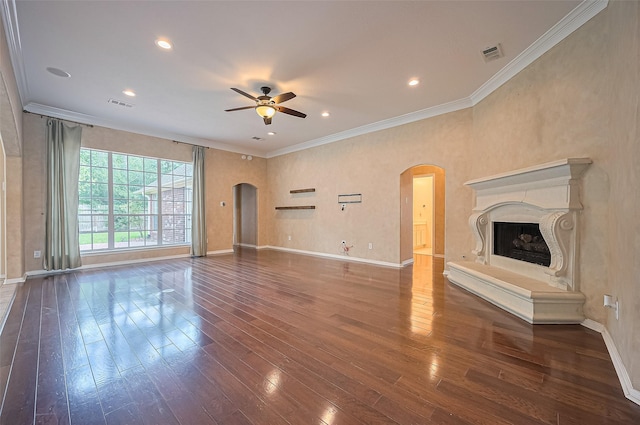 14610 Sandler Ct, Cypress, TX 77429 - unfurnished living room featuring arched walkways, ceiling fan, wood finished floors, crown molding, and a fireplace
