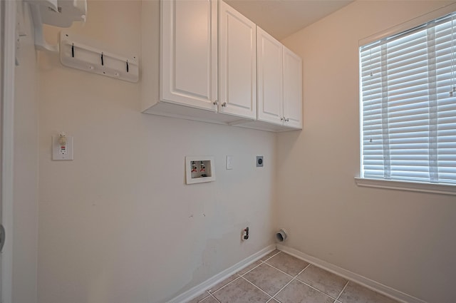 14610 Sandler Ct, Cypress, TX 77429 - laundry room with cabinet space, washer hookup, light tile patterned floors, and electric dryer hookup