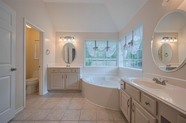 14610 Sandler Ct, Cypress, TX 77429 - bathroom featuring lofted ceiling, a whirlpool tub, two vanities, and tile patterned floors