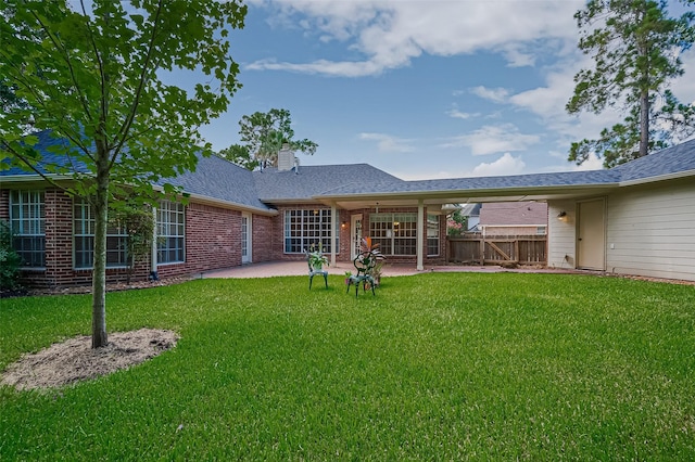 14610 Sandler Ct, Cypress, TX 77429 - rear view of house featuring a patio, a chimney, brick siding, and roof with shingles