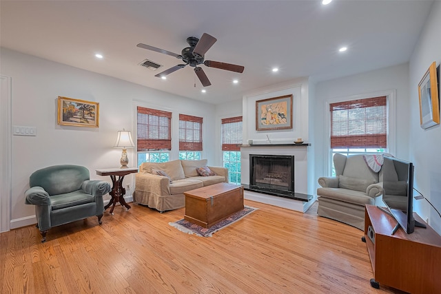 501 Gale St, Houston, TX 77009 - living area with a ceiling fan, light wood-style flooring, a fireplace with raised hearth, and recessed lighting