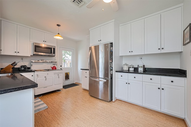 501 Gale St, Houston, TX 77009 - kitchen with stainless steel appliances, dark countertops, and white cabinetry