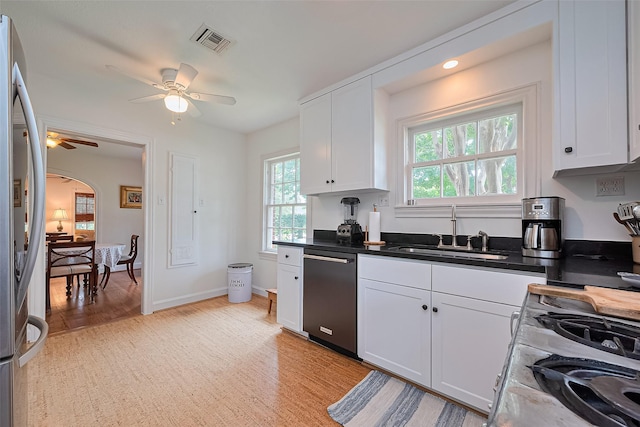 501 Gale St, Houston, TX 77009 - kitchen with appliances with stainless steel finishes, a ceiling fan, white cabinets, and light wood-style floors