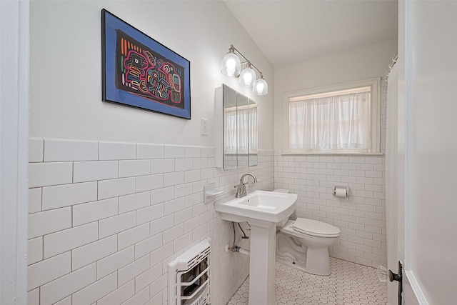 501 Gale St, Houston, TX 77009 - bathroom with heating unit, tile patterned flooring, tile walls, and wainscoting