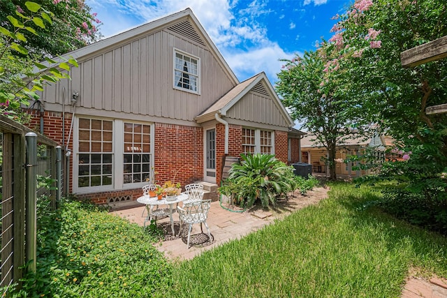 501 Gale St, Houston, TX 77009 - rear view of property with brick siding, a patio, board and batten siding, and entry steps