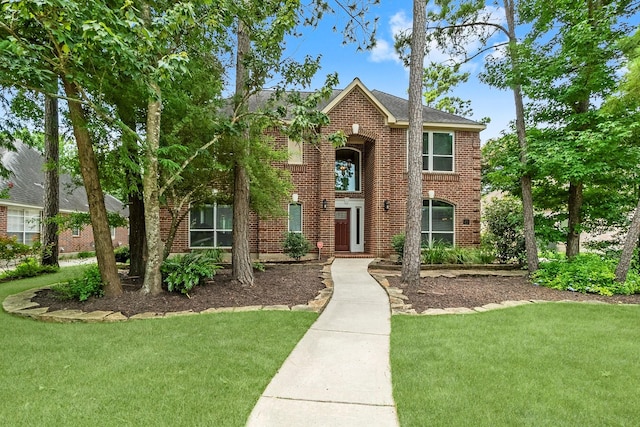 23 Sparklewood Pl, The Woodlands, TX 77381 - traditional-style home featuring a front yard and brick siding