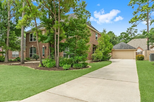 23 Sparklewood Pl, The Woodlands, TX 77381 - colonial inspired home with driveway, a front yard, and brick siding