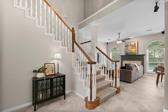 23 Sparklewood Pl, The Woodlands, TX 77381 - stairway with ceiling fan, tile patterned floors, and a fireplace
