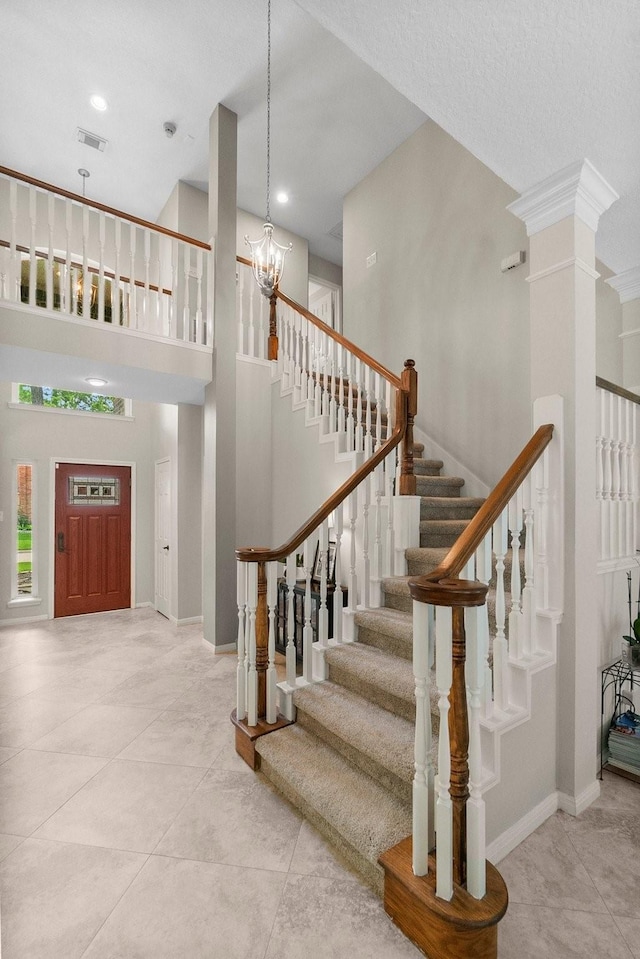 23 Sparklewood Pl, The Woodlands, TX 77381 - tiled entrance foyer with a towering ceiling, stairway, a chandelier, recessed lighting, and decorative columns