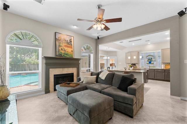 23 Sparklewood Pl, The Woodlands, TX 77381 - living room with light tile patterned floors, a ceiling fan, a tile fireplace, and recessed lighting