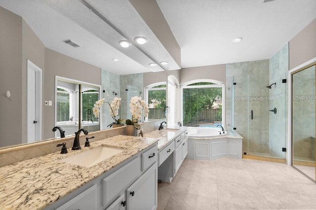23 Sparklewood Pl, The Woodlands, TX 77381 - full bath with double vanity, plenty of natural light, a stall shower, a garden tub, and recessed lighting