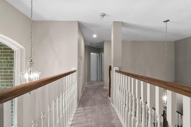 23 Sparklewood Pl, The Woodlands, TX 77381 - hallway with a chandelier, carpet, and an upstairs landing