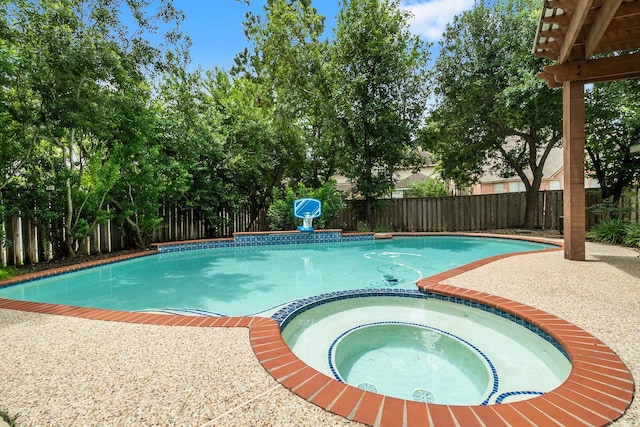 23 Sparklewood Pl, The Woodlands, TX 77381 - view of swimming pool with a fenced backyard, a pool with connected hot tub, and a patio area