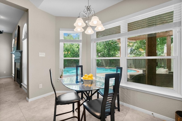 23 Sparklewood Pl, The Woodlands, TX 77381 - dining area featuring a chandelier, healthy amount of natural light, tile patterned floors, and a fireplace