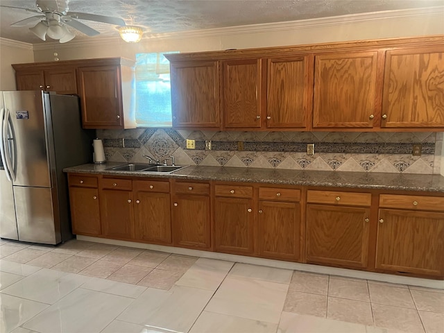 7001 Kassarine Pass, Houston, TX 77033 - kitchen featuring freestanding refrigerator, brown cabinetry, and ornamental molding