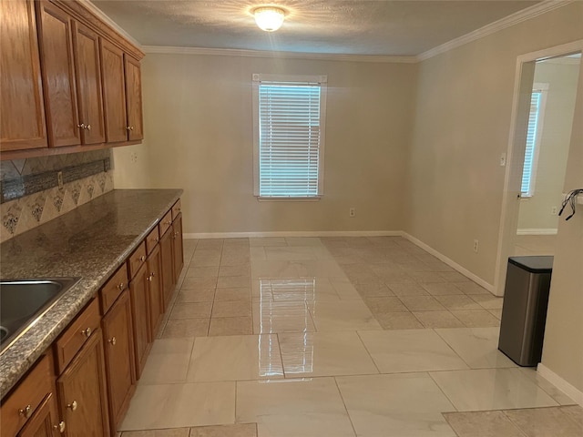 7001 Kassarine Pass, Houston, TX 77033 - kitchen with brown cabinetry, crown molding, dark stone counters, light tile patterned flooring, and backsplash