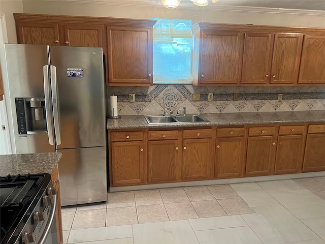 7001 Kassarine Pass, Houston, TX 77033 - kitchen with stainless steel appliances, brown cabinetry, tasteful backsplash, and crown molding