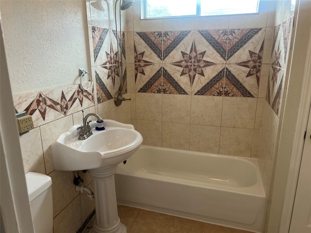 7001 Kassarine Pass, Houston, TX 77033 - bathroom with a textured wall, shower / washtub combination, tile walls, and tile patterned floors